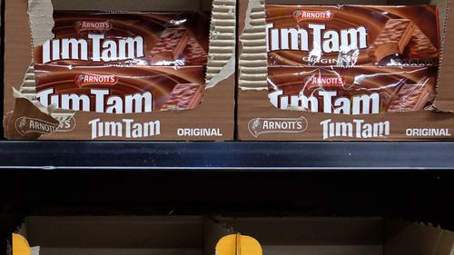 Tim Tams are cheaper in the UK than at Woolies and Coles. The supermarkets say they're not to blame