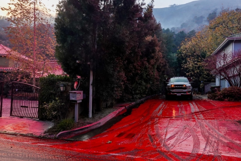 Los Angeles firefighters brace for return of Santa Ana winds as city bathed in hot pink flame retardant