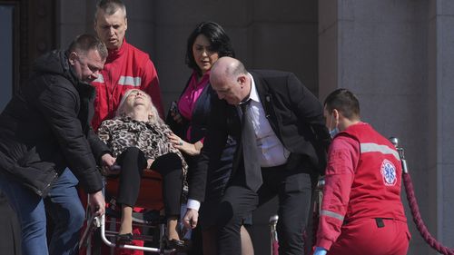 At least three Serbian lawmakers injured as smoke bombs and flares thrown in parliament